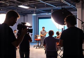 People filming a commercial on a set with professional lighting